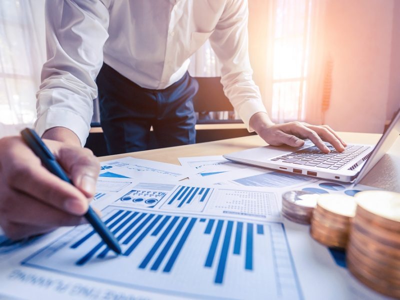 Businessman accountant or financial expert analyze business repo Businessman accountant or financial expert analyze business report graph and finance chart at corporate office. Concept of finance economy, banking business and stock market research.